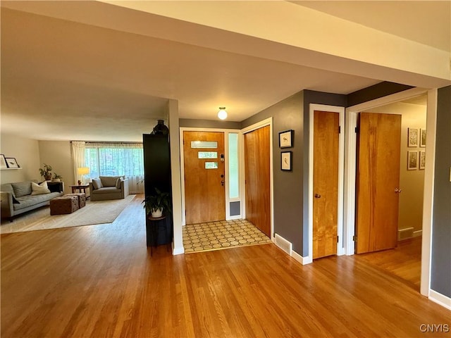entryway with wood finished floors and baseboards