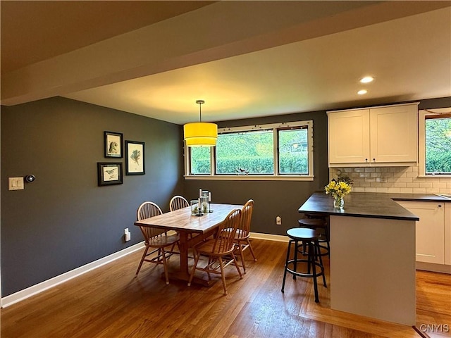 dining room featuring wood finished floors, baseboards, and recessed lighting