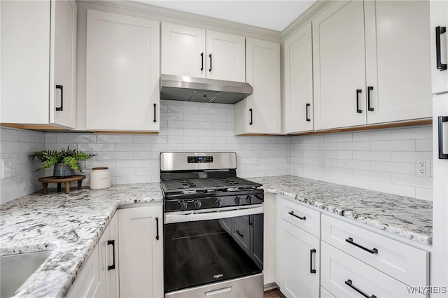 kitchen with gas stove, under cabinet range hood, backsplash, light stone counters, and white cabinets