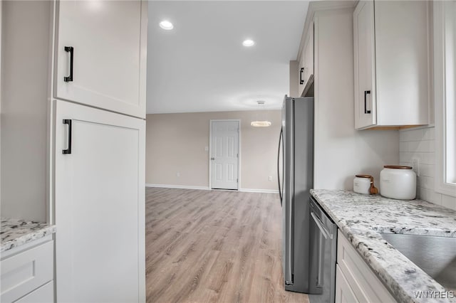 kitchen with stainless steel appliances, light wood-style flooring, white cabinetry, baseboards, and recessed lighting
