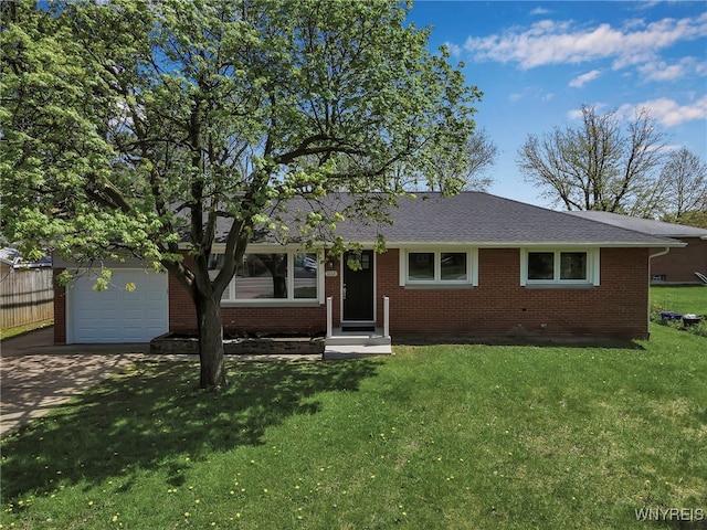 view of front of home featuring brick siding, a front yard, driveway, a garage, and roof with shingles