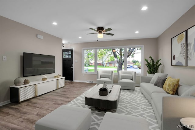 living room with wood finished floors, baseboards, a ceiling fan, and recessed lighting