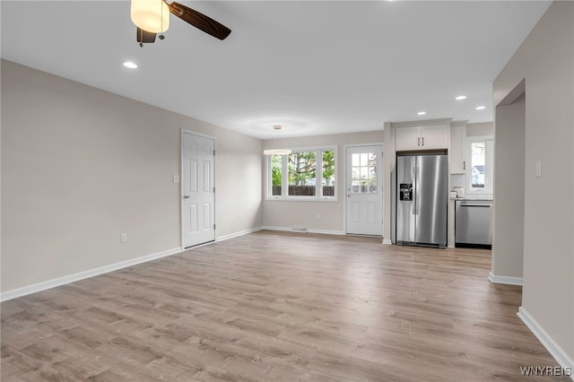 unfurnished living room featuring ceiling fan, light wood-type flooring, baseboards, and recessed lighting