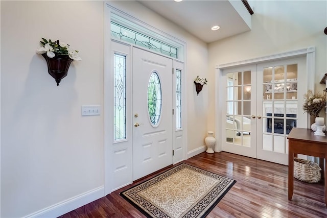 entrance foyer featuring french doors, wood finished floors, and baseboards
