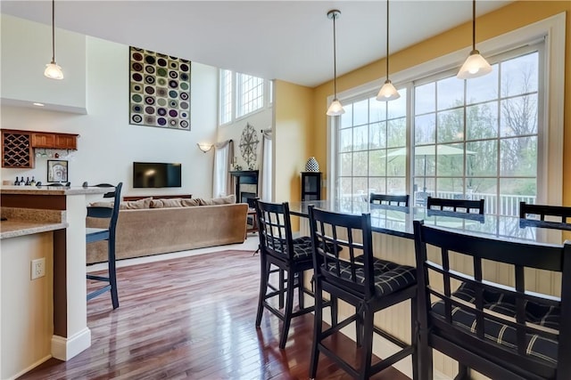 dining area featuring dark wood-type flooring and baseboards