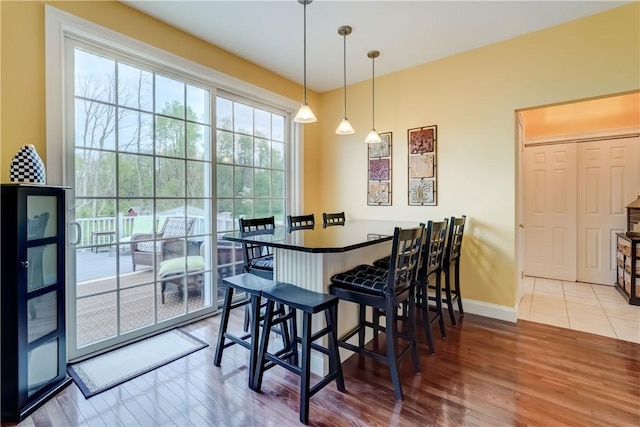 dining space featuring wood finished floors and baseboards