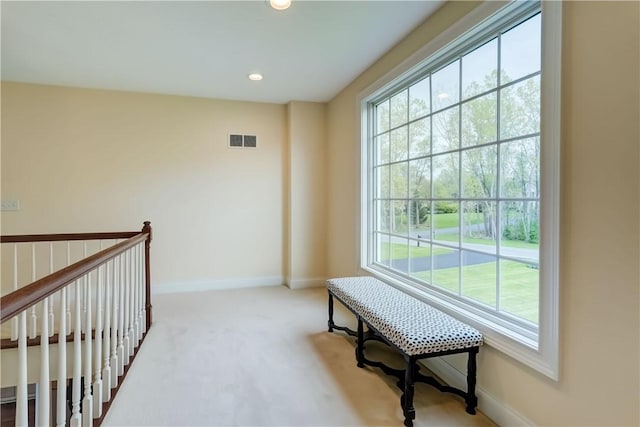 hallway featuring carpet flooring, baseboards, and recessed lighting