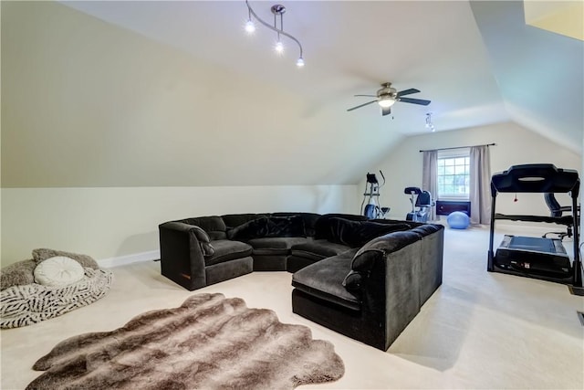 carpeted living area with a ceiling fan, vaulted ceiling, and baseboards
