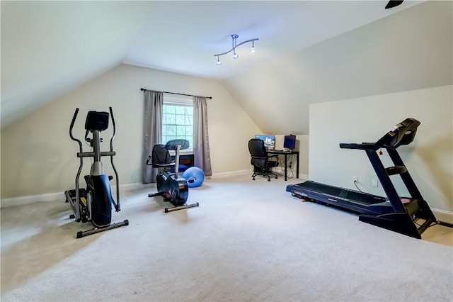 exercise area featuring vaulted ceiling, baseboards, and carpet floors