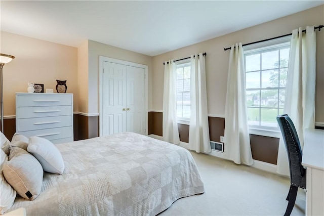 bedroom with carpet and a closet