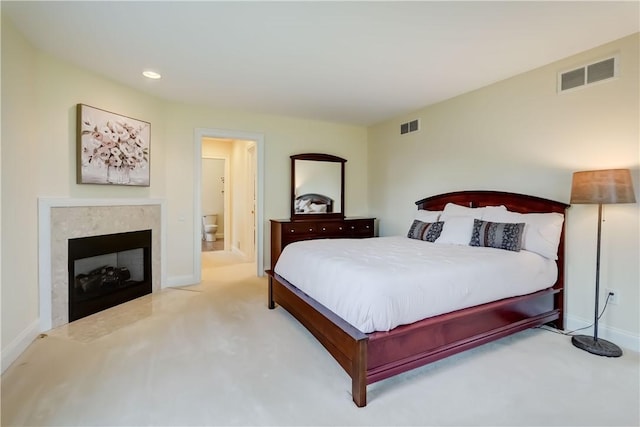 carpeted bedroom featuring a high end fireplace, baseboards, recessed lighting, and ensuite bathroom