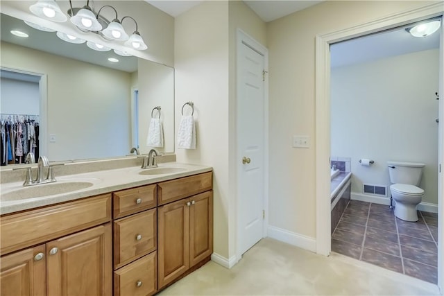 full bath featuring double vanity, toilet, baseboards, and a bath
