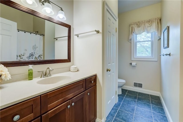 full bath with vanity, toilet, baseboards, and tile patterned flooring