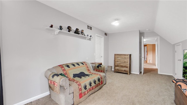 living area with carpet flooring, baseboards, and lofted ceiling