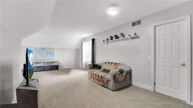 living area with carpet floors, vaulted ceiling, and baseboards
