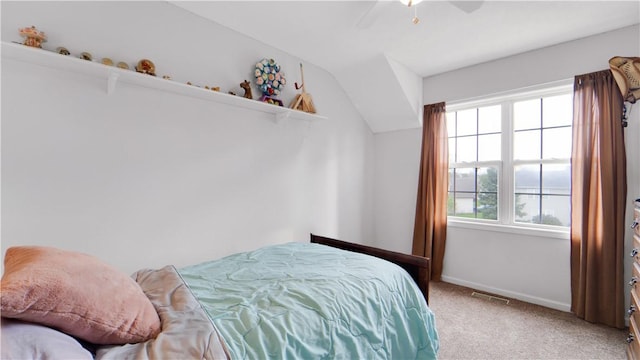 bedroom with carpet, baseboards, ceiling fan, and vaulted ceiling