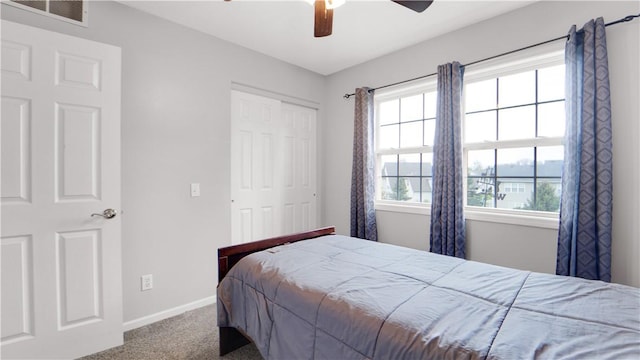 bedroom with carpet floors, a closet, baseboards, and multiple windows