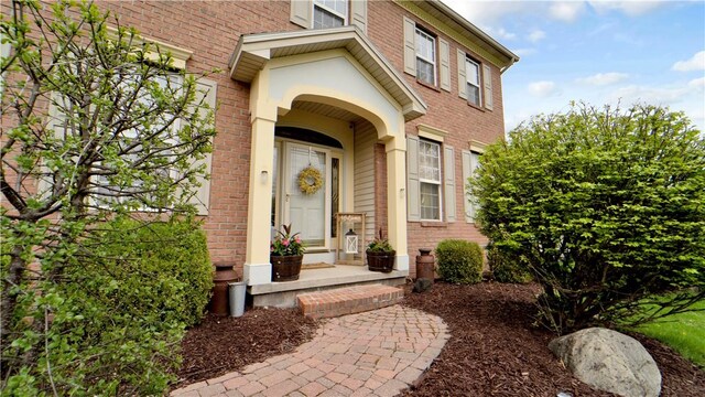 property entrance featuring brick siding