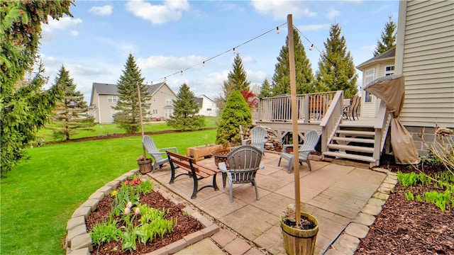 view of patio featuring a wooden deck, a fire pit, and a residential view