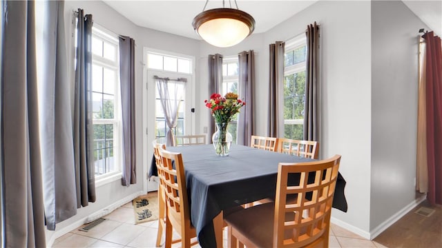dining space with light tile patterned flooring and baseboards