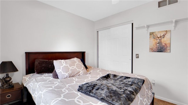 bedroom featuring a closet, baseboards, and carpet
