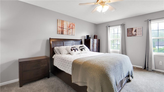 bedroom with light carpet, baseboards, and ceiling fan