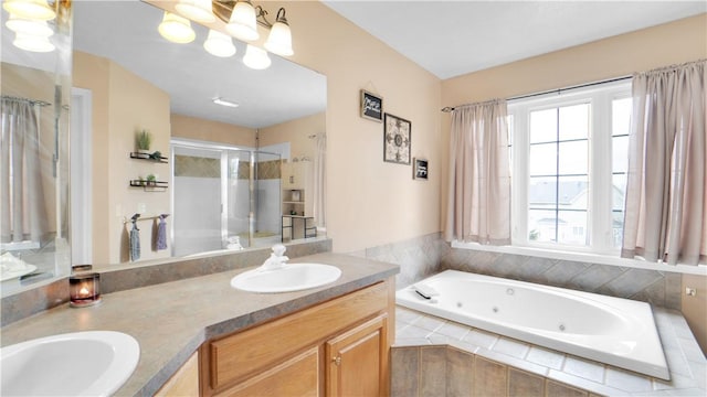 full bath featuring a shower stall, a tub with jets, and double vanity