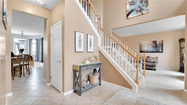 stairway with tile patterned flooring and baseboards