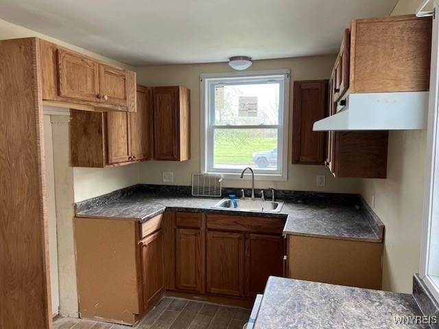 1026 93rd St, Niagara Falls, NY 14304 - kitchen featuring a sink, brown cabinetry, and wood finished floors