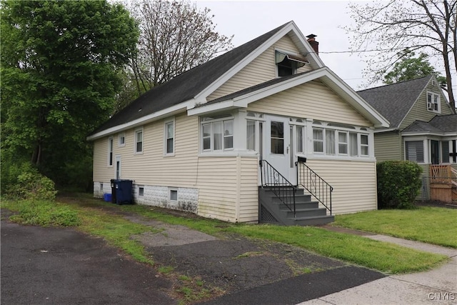 bungalow-style home with entry steps and a chimney