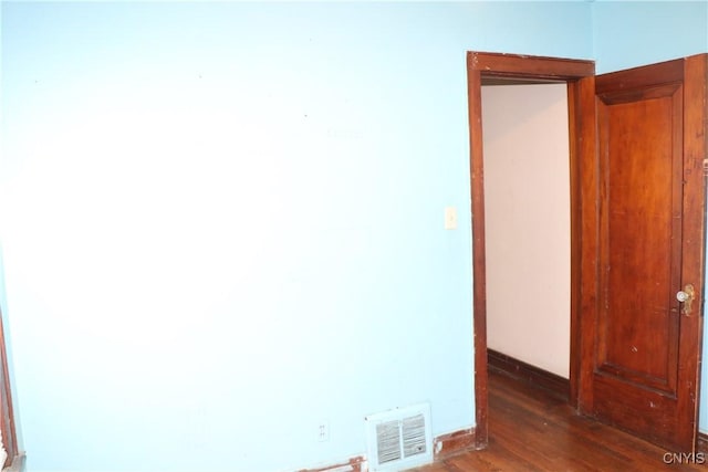 unfurnished room featuring hardwood / wood-style floors and baseboards