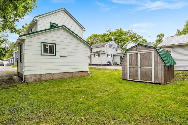 10 Clinton St, Bergen, NY 14416 - rear view of house with a storage shed, a yard, and an outdoor structure