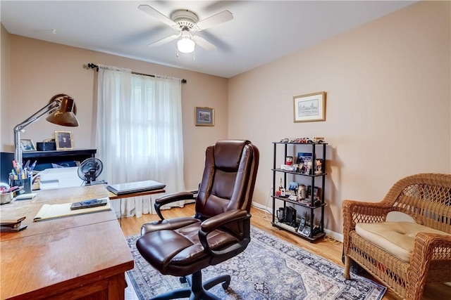 home office with ceiling fan, light wood-style flooring, and baseboards