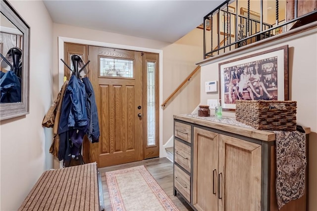 entryway featuring stairway and light wood-style flooring