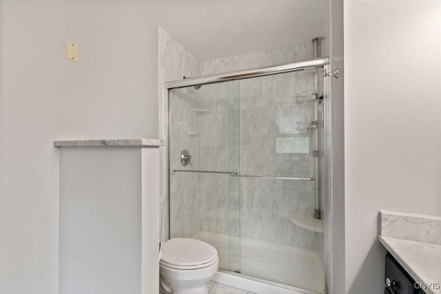 full bath with a shower stall, toilet, and vanity