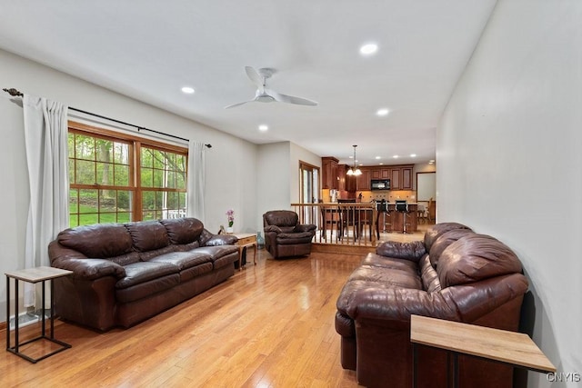 living area featuring ceiling fan, light wood-style floors, and recessed lighting