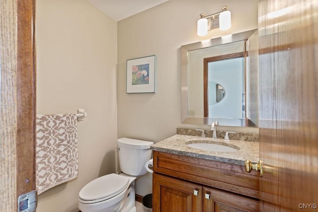 bathroom featuring toilet and vanity