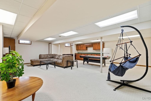 living room featuring light colored carpet and a paneled ceiling