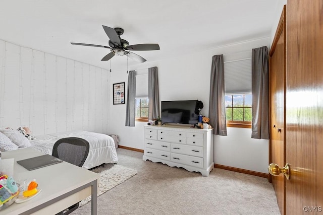 bedroom featuring baseboards, light carpet, and a ceiling fan
