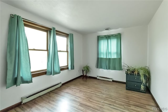 353 Campbell Rd, Sweden, NY 14420 - spare room featuring baseboard heating, wood finished floors, and baseboards