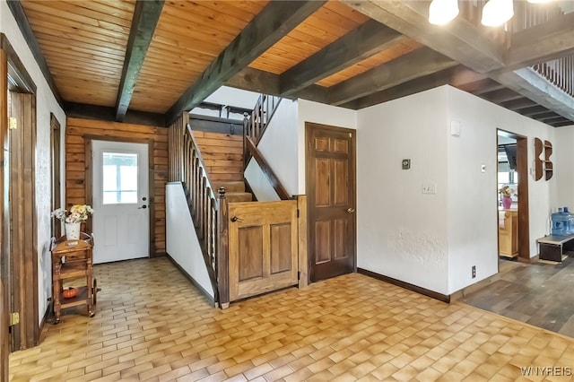 353 Campbell Rd, Sweden, NY 14420 - entryway featuring stairway, baseboards, wooden ceiling with exposed beams, and brick patterned floors