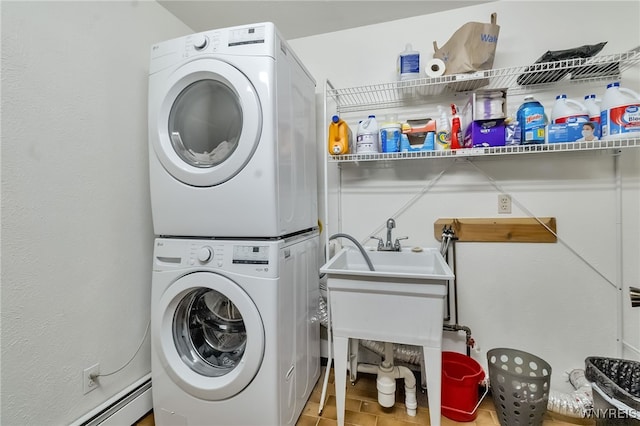 353 Campbell Rd, Sweden, NY 14420 - laundry area featuring stacked washing machine and dryer, baseboard heating, and tile patterned flooring