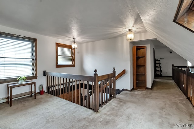 353 Campbell Rd, Sweden, NY 14420 - corridor featuring an upstairs landing, carpet flooring, lofted ceiling, and baseboards