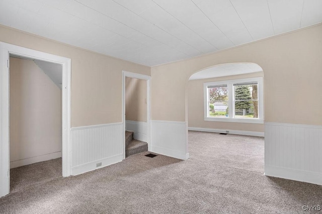 6 E 6th St, Oswego-City, NY 13126 - carpeted empty room with a wainscoted wall and stairway