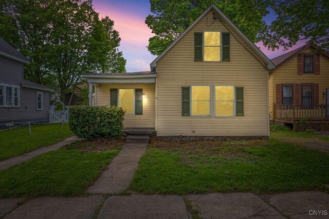 6 E 6th St, Oswego-City, NY 13126 - view of front facade with a front yard
