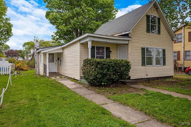 6 E 6th St, Oswego-City, NY 13126 - view of front of property with a front yard and a chimney