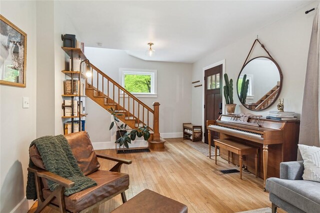 314 Hamilton St, Benton, NY 14527 - living area featuring stairs, light wood-style floors, and baseboards