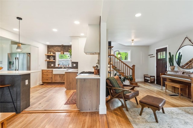 314 Hamilton St, Benton, NY 14527 - kitchen with stainless steel refrigerator with ice dispenser, light countertops, light wood-style flooring, open shelves, and recessed lighting