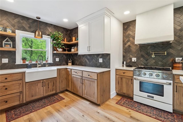 314 Hamilton St, Benton, NY 14527 - kitchen featuring stainless steel range with gas stovetop, open shelves, a sink, backsplash, and light countertops