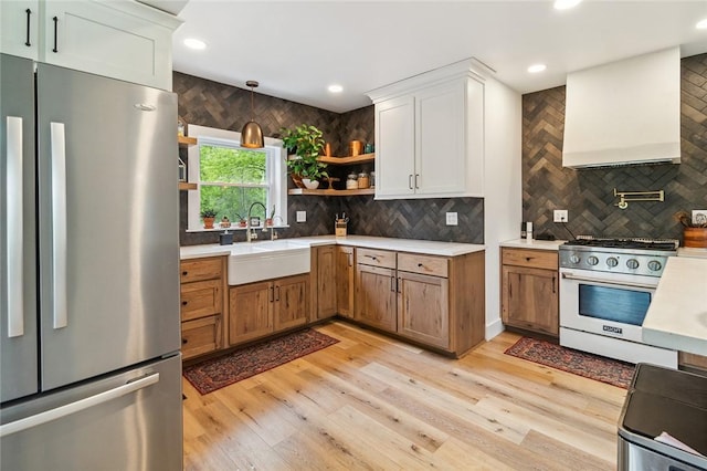 314 Hamilton St, Benton, NY 14527 - kitchen with stainless steel appliances, a sink, open shelves, wall chimney exhaust hood, and light countertops